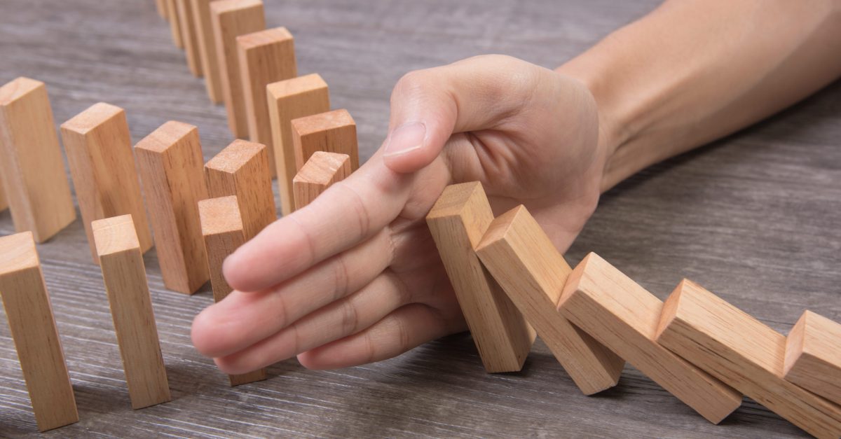 Hand,Stopping,Wooden,Block,Domino.,Concept,Prevent,And,Solution.
